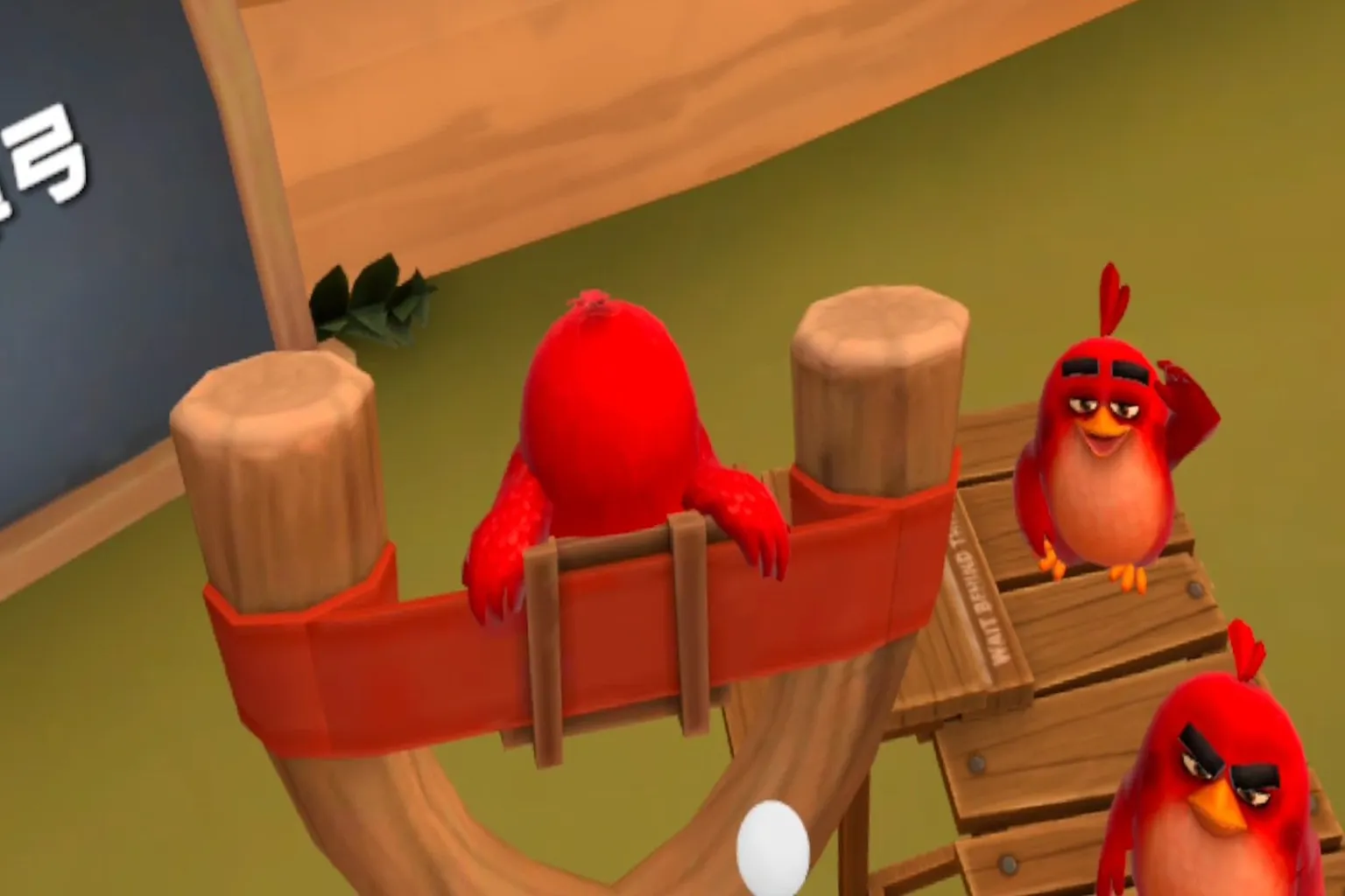Angry Birds VR gameplay scene where Red jumps into the slingshot to prepare for launch, while other Reds cheer and clap behind him.