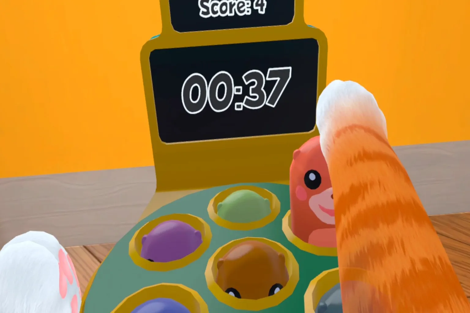 Using its front paws, the cat plays a whack-a-mole mini-game, showing that even cats can join simple, kid-friendly activities.