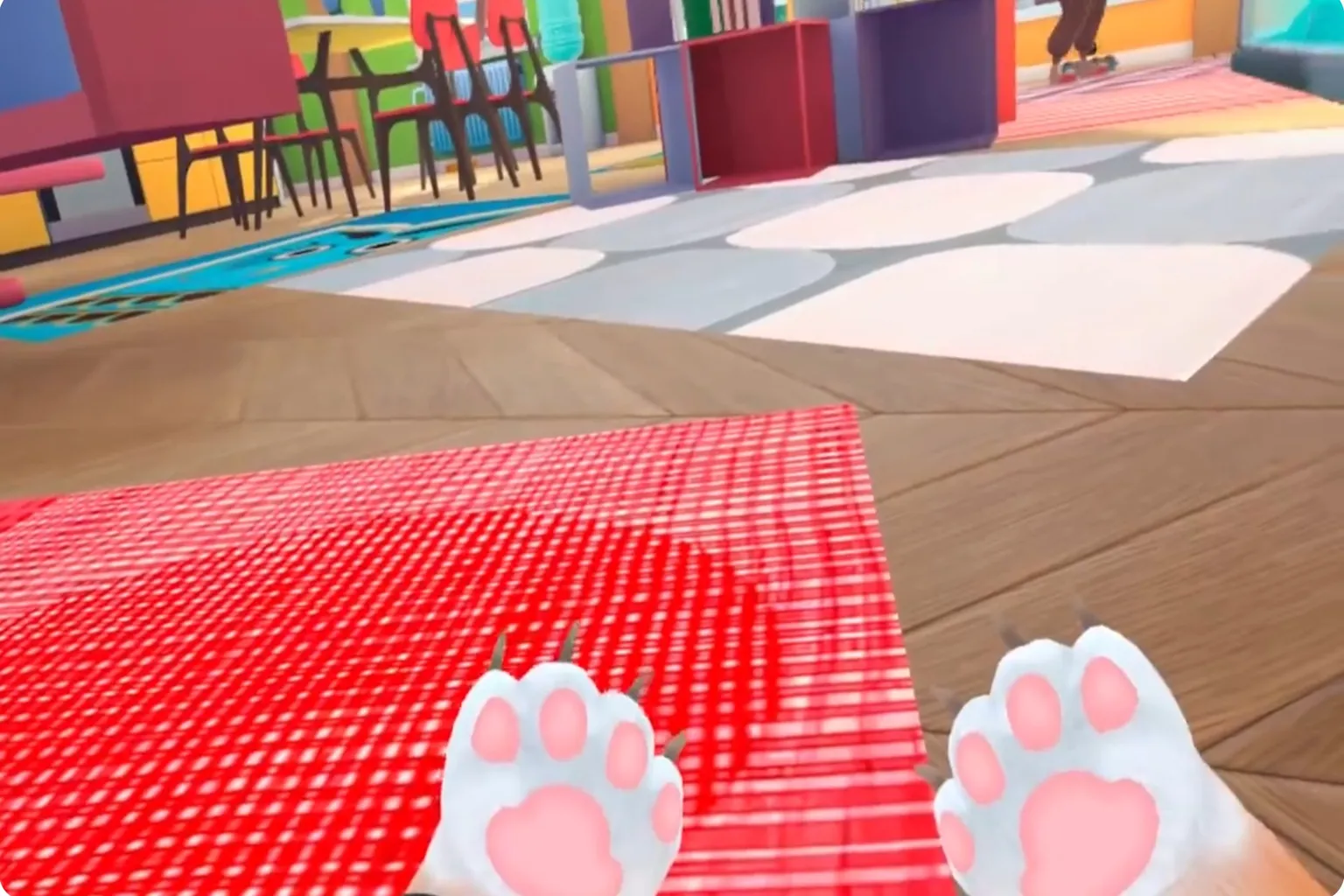 From a low viewpoint, the pink front paws of the player’s cat are visible as an orange-and-white cat sits on the carpet, quietly observing human life.