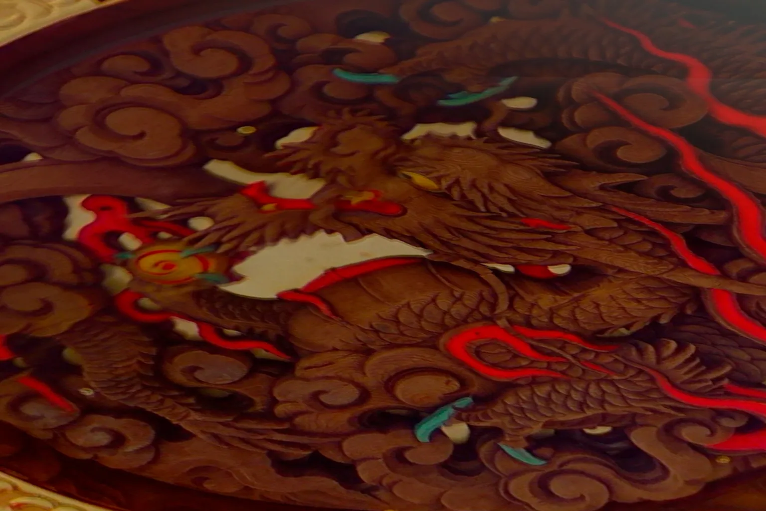 Close-up view of the wooden dragon carving beneath the giant red lantern at Kaminarimon Gate, highlighting the detailed craftsmanship of traditional Japanese woodwork.