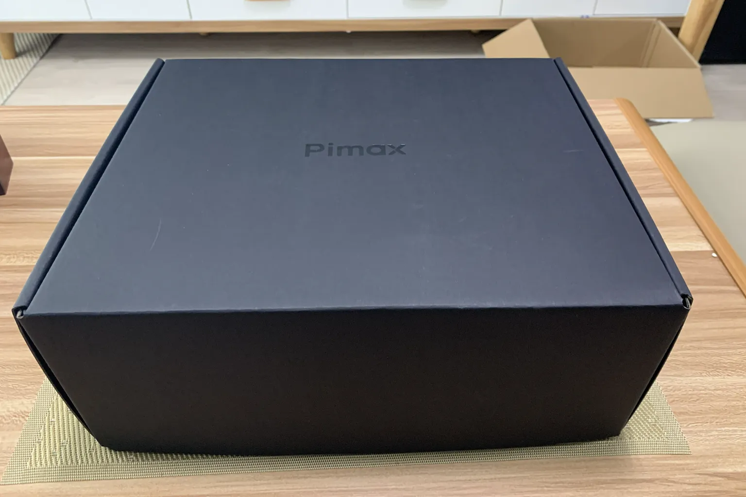 Plain black Pimax Crystal Light box placed on a table before unboxing.